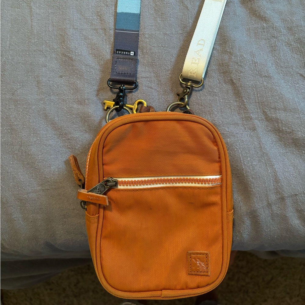 Thread crossbody, two straps available. Both pictured and included.